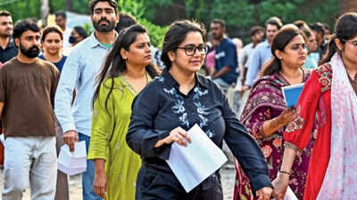 NEET-PG aspirants arrive at an examination centre to appear for the medical entrance exam on August 30 How rules operate differently for foreign, Indian MBBS graduates