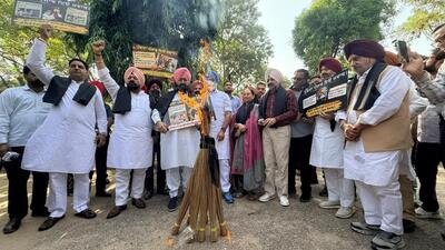 Leader of opposition Partap Singh Bajwa along with Congress MLAs burning brooms to protest against the AAP government outside the Punjab assembly in Chandigarh on Tuesday. (Ravi Kumar/HT) Leader of opposition Partap Singh Bajwa along with Congress MLAs burning brooms to protest against the AAP government outside the Punjab assembly in Chandigarh on Tuesday. (Ravi Kumar/HT)